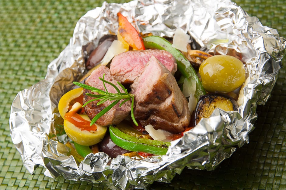 Pork tenderloin on vegetables in aluminum foil, Fielt roasted pink