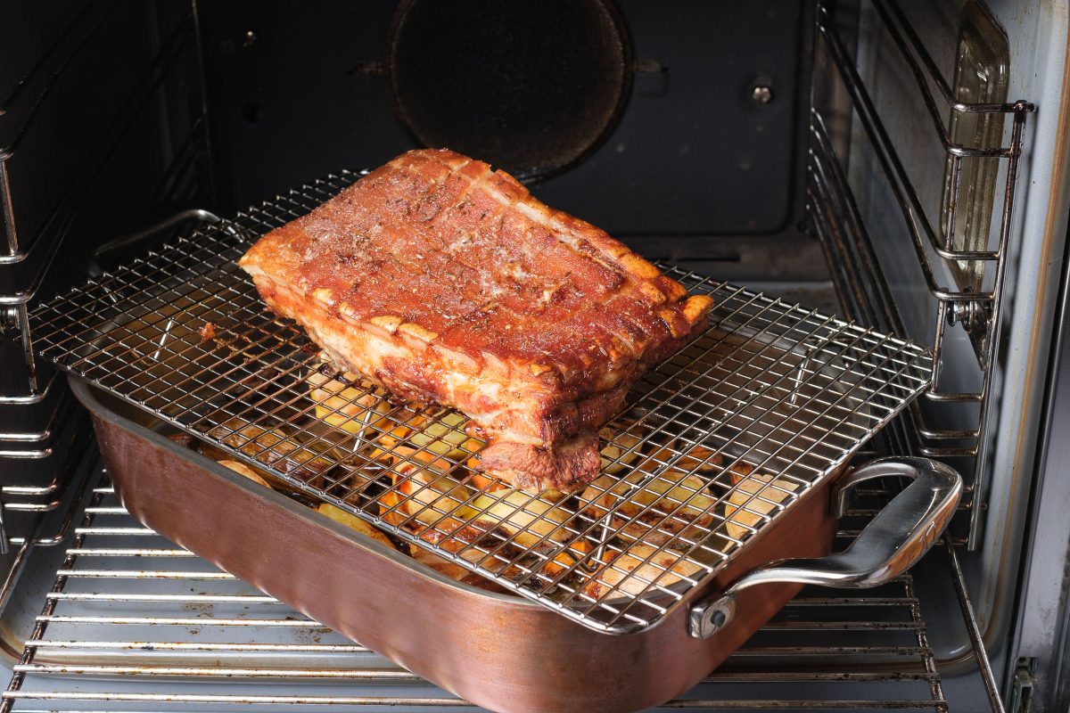 Roast pork belly in the oven on lattice