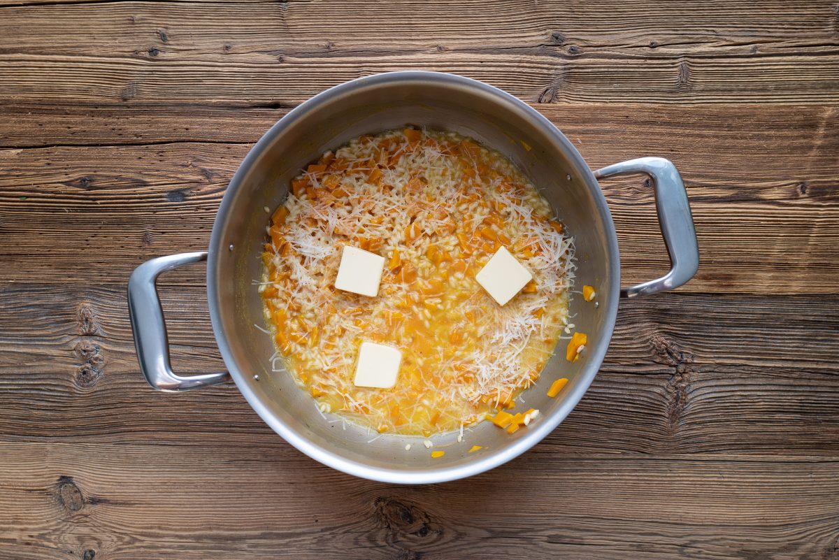 Stir pumpkin risotto with butter and cheese
