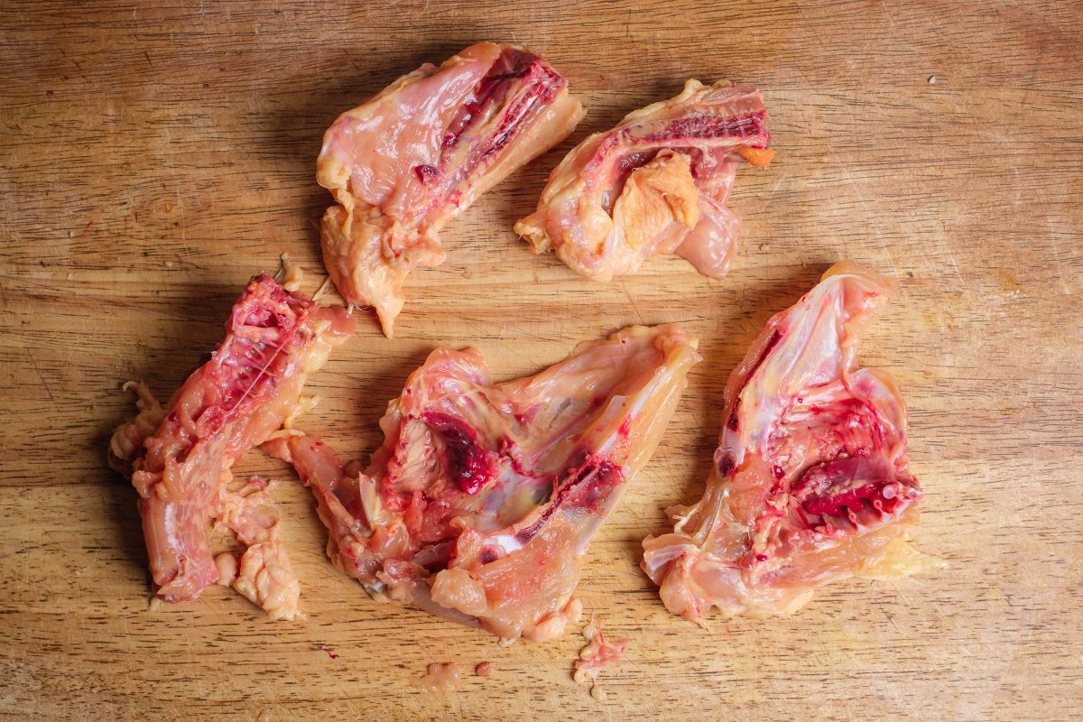 Chicken bones chopped on the cutting board