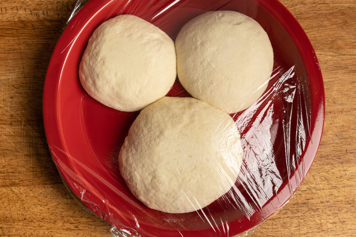 Pizza dough balls covered with foil
