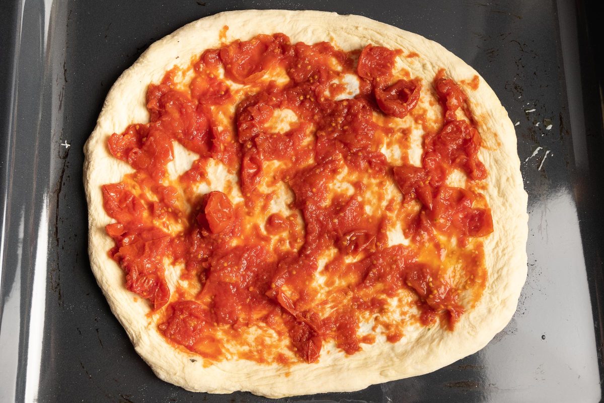 pizza dough topping with tomatoes