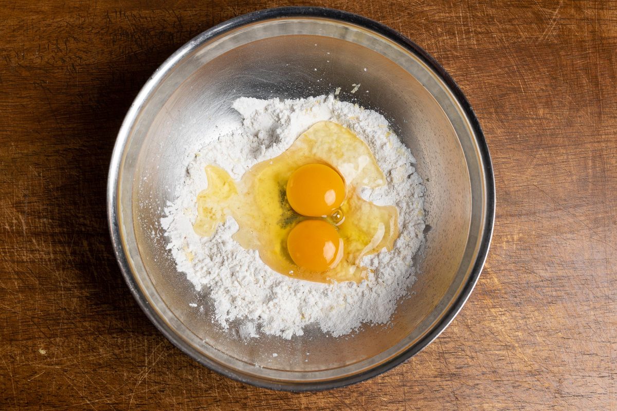 Add eggs to flour for pancake batter.