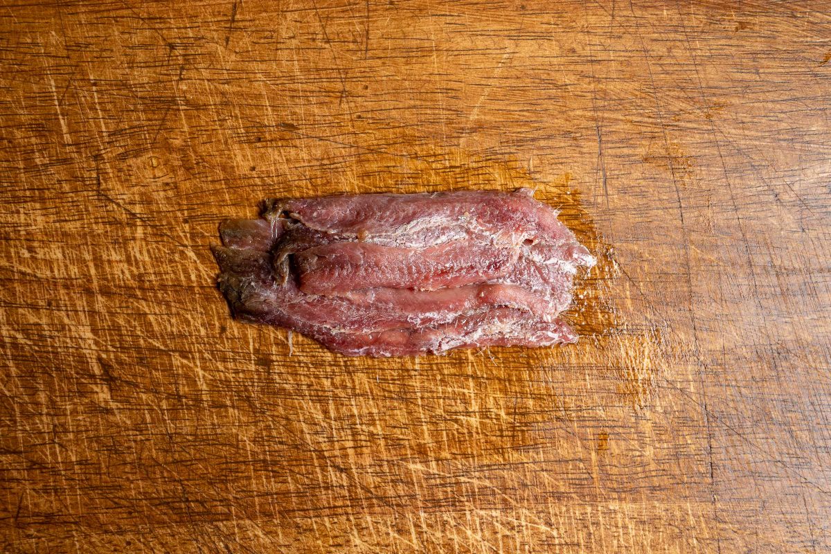 Anchovy fillets on cutting board