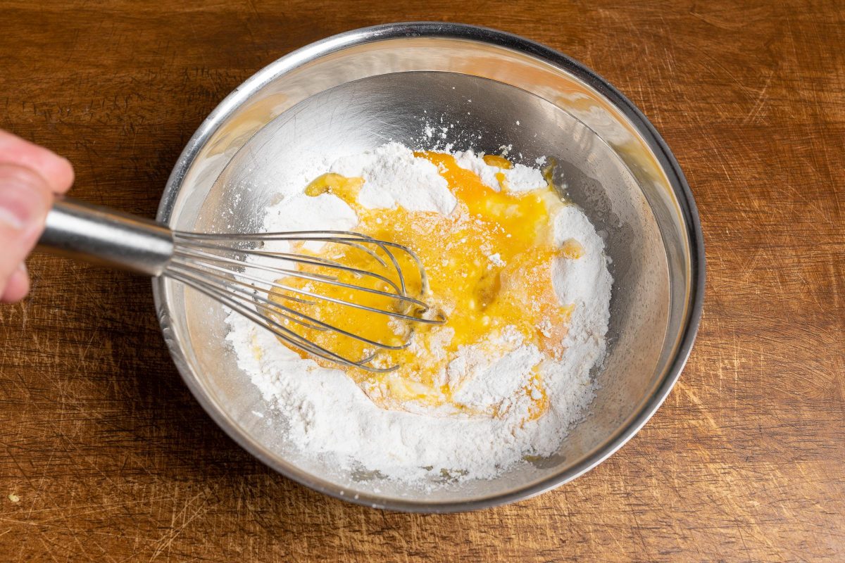 Mix eggs and flour for pancake batter.