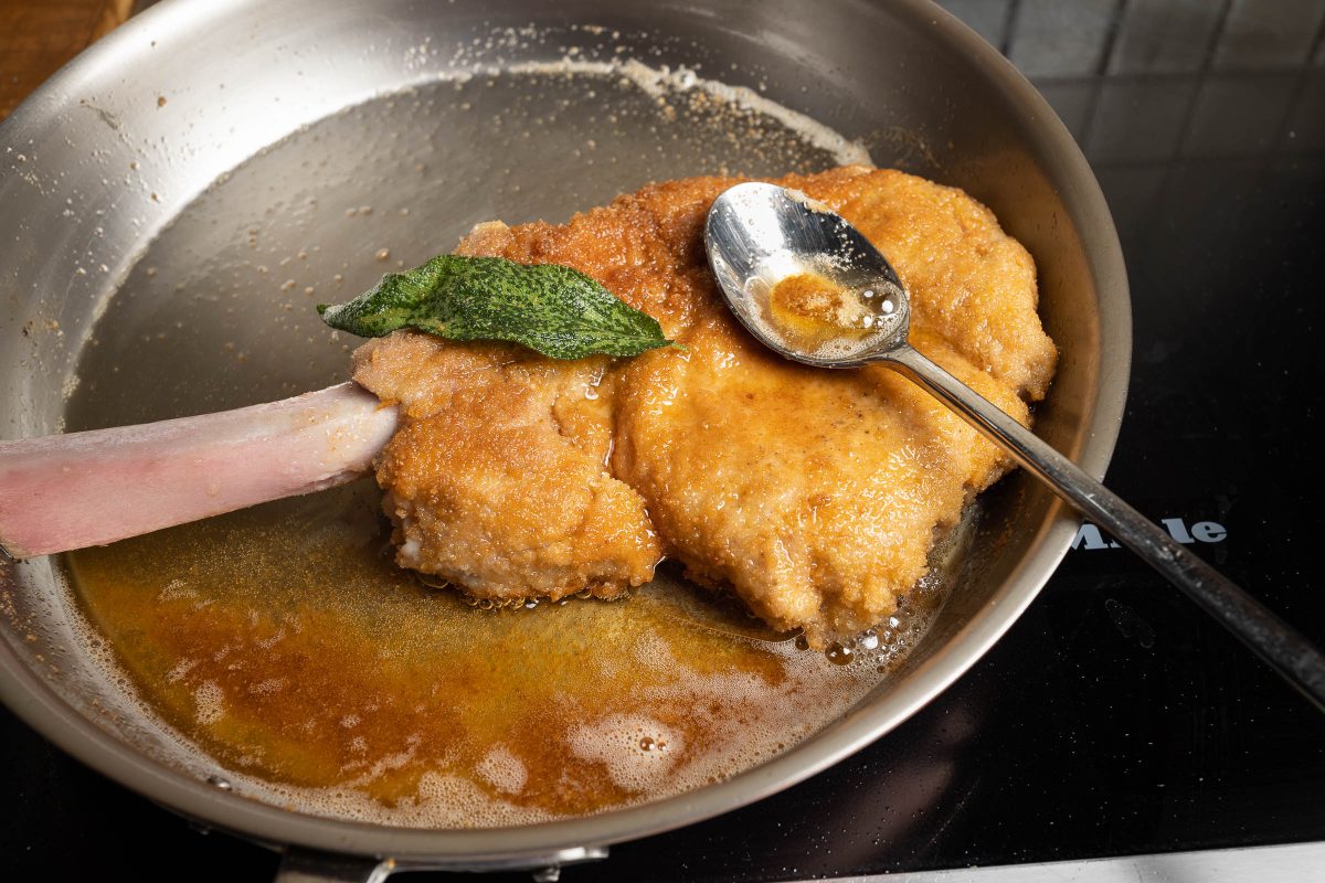 Drizzle Cotoletta Milanese with clarified butter